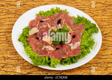 Beef carpaccio with parmesan cheese and salad leaves Stock Photo