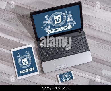 Compliance concept shown on different information technology devices Stock Photo