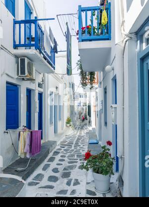 Colorful houses, blue and red doors and windows and lots of flowers in the old town of Mykonos Island, Greece. Stock Photo