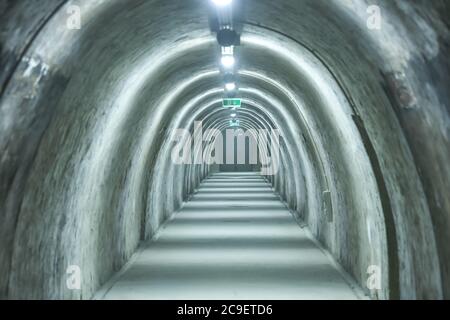 Old concrete tunnel with fluorescent lights. Stock Photo
