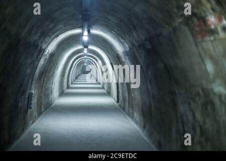 Old concrete tunnel with fluorescent lights. Stock Photo