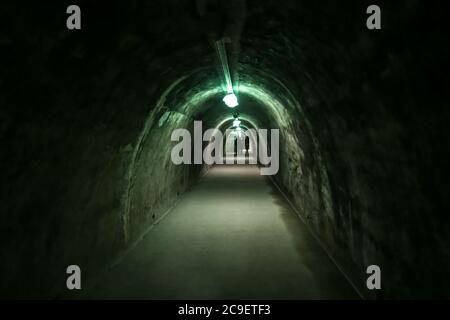 Old concrete tunnel with fluorescent lights. Stock Photo