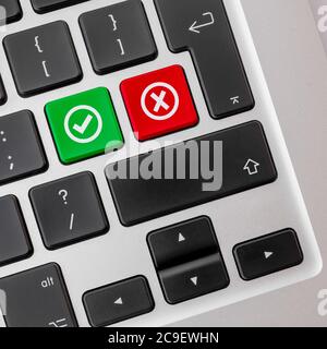 Computer keyboard with buttons for green checkbox and red cross. Stock Photo