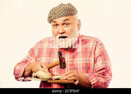 Shoe repair. mature shoemaker in workshop make shoes. shoemaker working with leather textile and hammer at workshop. retro man repair shoes with hammer. Cobbler workmanship. shoemaker at work. Stock Photo