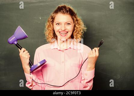 Teacher hold table lamp in hand chalkboard background. Knowledge day. Insight and idea. Educational idea. Woman work on bright shiny idea. Creativity and inspiration. Light up process of studying. Stock Photo