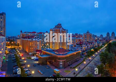 Night aerial view on Obolon area of Kyiv city with illumination. Flying drone camera shot. Stock Photo