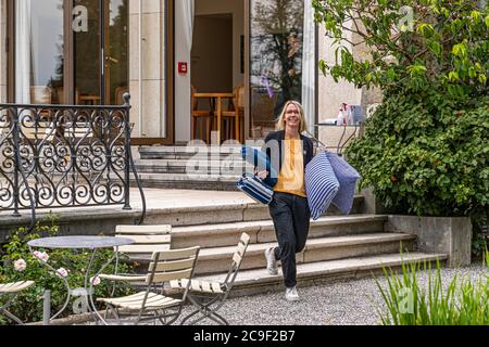 Reinhart Collection formed by Oskar Reinhart in Winterthur, Switzerland. Best prepared for a picnic in the park. Angela Berg sets out on the path - the historic path - on which Oskar Reinhart walked through his garden. Today, places under old fruit trees have been mowed free in three places there Stock Photo