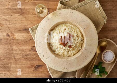 Risoto with chanterelle mushrooms in large plate. Classic hot dish of rice, cheese and wine. Stock Photo