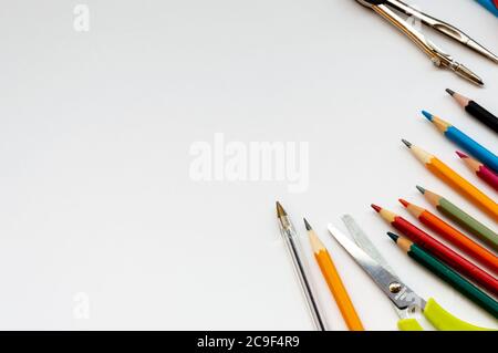School supplies on white background with colored pencils, scissors and pen Stock Photo