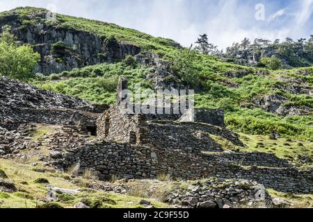 Ruins of old slate quarry buildings at Tilberthwaite in the Lake District National Park, Cumbria, on a sunny summer day in July. Stock Photo