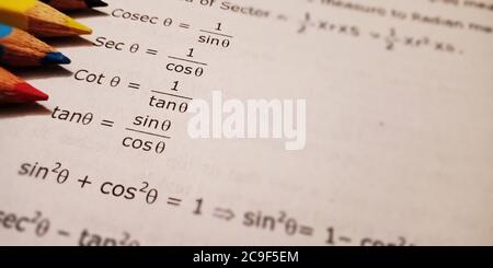 trigonometry sin cos tan maths educational text displayed on paper in english language on numerical format background. Stock Photo