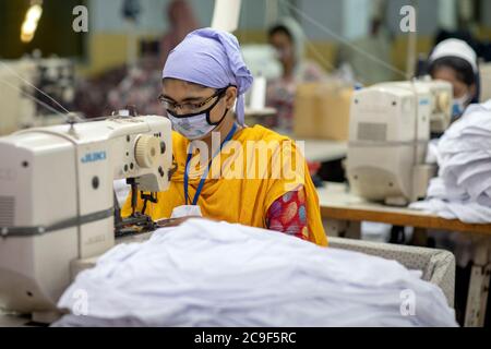 Dhaka, Bangladesh. 25th July, 2020. Women work in a textile factory. Bangladesh is the second largest producer of textiles after China. The working conditions and the environmental protection of the local production gives rise to repeated criticism. In Bangladesh, thousands of factory employees - mainly women - have lost their jobs in the corona crisis, after international fashion chains cancelled many orders due to corona. Credit: K M Asad/dpa/Alamy Live News Stock Photo