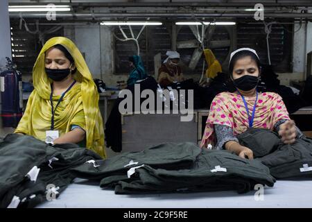 Dhaka, Bangladesh. 25th July, 2020. Women work in a textile factory. Bangladesh is the second largest producer of textiles after China. The working conditions and the environmental protection of the local production gives rise to repeated criticism. In Bangladesh, thousands of factory employees - mainly women - have lost their jobs in the corona crisis, after international fashion chains cancelled many orders due to corona. Credit: K M Asad/dpa/Alamy Live News Stock Photo