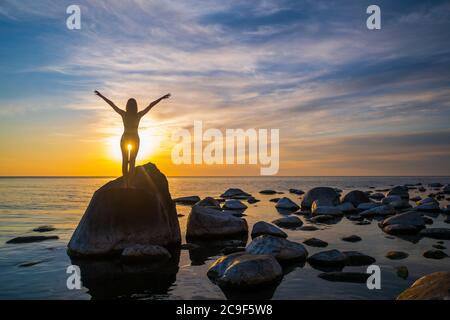 Unrecognizable woman enjoying freedom during sunset Stock Photo