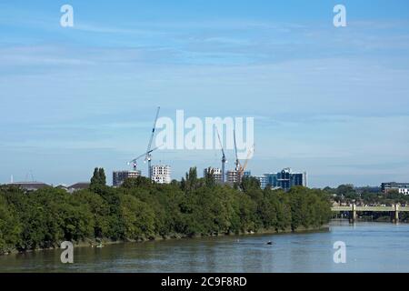 view from chiswick bridge, london, england, towards cranes and partially completed buildings around kew bridge, including brentford fc's stadium Stock Photo