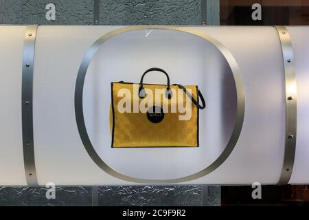 Yellow Gucci brand 'Off the Grid' tote handbag on display in window, Gucci Store Bond Street, London, UK Stock Photo