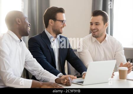 Happy diverse colleagues having pleasant conversation during break Stock Photo