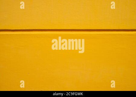 Saturated yellow background surface with offset black horizontal line ...