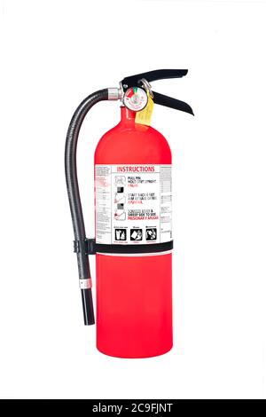 A classic red fire extinguisher isolated on white for use as a design element or safety inference for home and business protection. Stock Photo