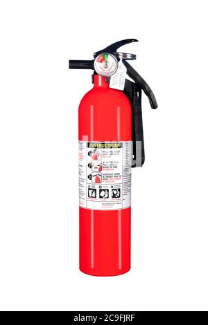 A classic red fire extinguisher isolated on white for use as a design element or safety inference for home and business protection. Stock Photo