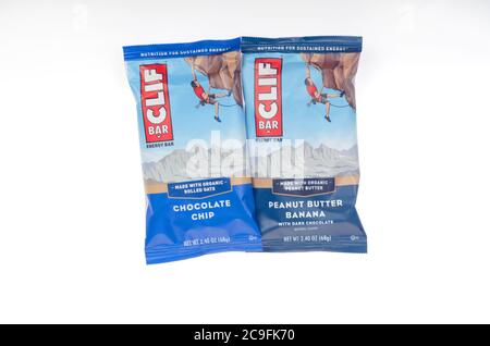 2 Clif energy Bars on white in wrappers. One is organic Peanut butter banana with dark chocolate, the other is Chocolate chip with organic rolled oats Stock Photo