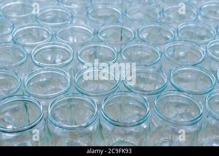 transparent empty glass bottles in a bottling plant, on a production line in a factory or for sale in a store Stock Photo