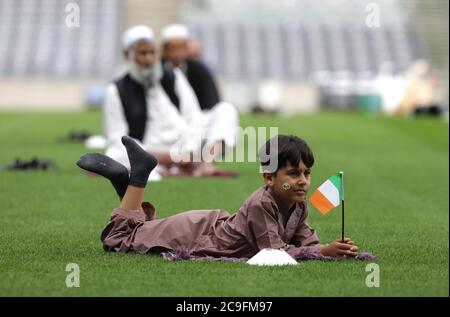 Kamil Ayub, aged 6, holds an Irish flag in Croke Park, Dublin, as mosques across Ireland are marking the occasion of Eid Al Adha, the festival of sacrifice - with the largest event taking place at GAA headquarters in Dublin. Stock Photo