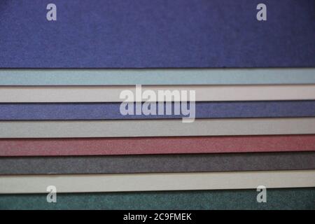 Purple blue grey teal mint background texture of colored paper on wooden table Stock Photo
