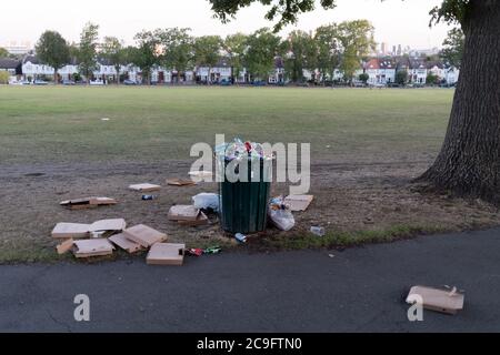 After a late-night party by park-users during the Coronavirus pandemic, litter and waste is strewn across the grass in Ruskin Park, on 30th July 2020, in Lambeth, south London, England. Stock Photo