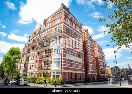 London- July, 2020: Typical red brick mansion building on North End Road in West Kensington Stock Photo