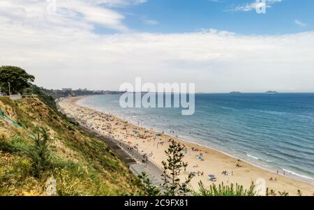 Poole, UK. 31st July, 2020. Bournemouth, UK. Friday 31 July 2020. Bournemouth beach is busy with people swimming in the sea as a weekend of hot weather gets going. Credit: Thomas Faull/Alamy Live News Stock Photo