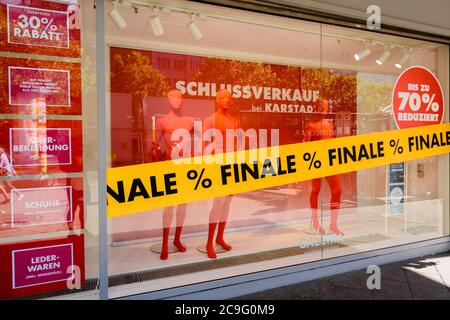 Berlin, Berlin, Germany. 30th July, 2020. Several signs indicating discounts can be seen in a shop window of the Karstadt branch on Berlin KurfÃ¼rstendamm. The department store group Galeria Karstadt Kaufhof GmbH had got into difficulties due to the corona-caused closure of all stores during the worldwide Covid-19 pandemic. In mid-June, the company announced the closure of 62 of its 172 department stores as part of its restructuring plans, most of the closures are in the state of Berlin. In the meantime, the number has fallen to 50 nationwide. Credit: Jan Scheunert/ZUMA Wire/Alamy Live News Stock Photo