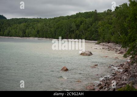 Waves wash a stony beach on Lake Superior's northern shore. Stock Photo