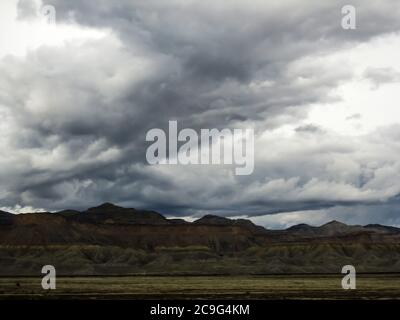 Storm clouds gathering over the La Sal Mountains in the eastern Utah, USA, as seen from the I-70 Stock Photo