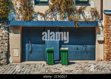 Trash cans and garage doors in a luxury building in Paris, France Stock Photo