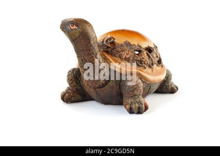 Wooden turtle figurine isolated on white background. Stock Photo