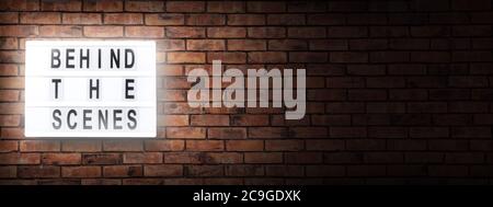 behind the scenes- letterboard text -  background with copy space on red bricks wall Stock Photo