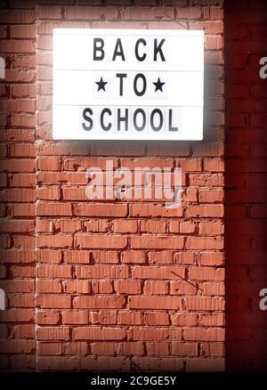 back to school letterboard text -  background with copy space on red bricks wall Stock Photo