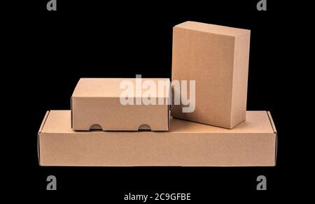 closing a stack of cardboard boxes on a black background with clipping path Stock Photo