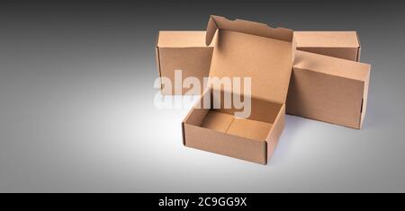 closing a stack of cardboard boxes on a grey background with clipping path Stock Photo