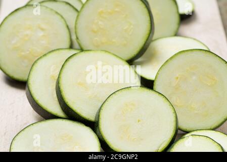 slices of raw zucchini on plate closeup Stock Photo