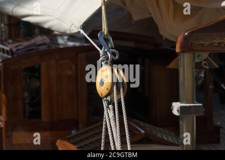 Rope pulley blocks marine vintage on an old Sailboat. Nautical detail on a dark background Stock Photo