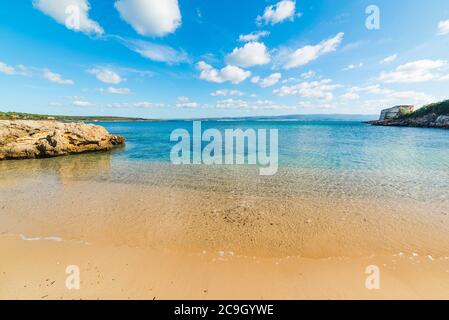 Golden shore in a small cove in Alghero shore. Sardinia, Italy Stock Photo