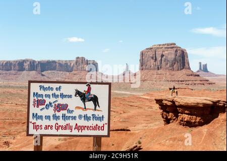 Commercialization, tourism, sign Photo of man on the horse, man on horse, geology, erosion landscape, table mountains, John Ford's Point, Monument Stock Photo