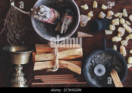 Flat lay various air element objects to use in witchcraft wicca on witch's altar filled with sage smudge sticks incense, Palo Santo tree, frankincense Stock Photo