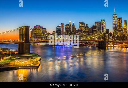 View of the Brooklyn Bridge and the Lower Manhattan skyline at sunset from the Manhattan Bridge; New York, NY Stock Photo