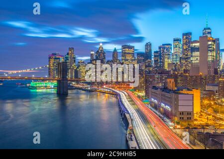 View of Lower Manhattan, the FDR and Brooklyn Bridge at sunset, taken from the Manhattan Bridge Stock Photo