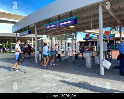 Orlando,FL/USA-7/25/20: People wearing face masks and social distancing while going through security at  Walt Disney World Resorts in Orlando, FL. Stock Photo