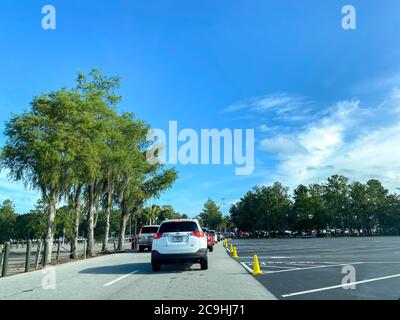 Orlando,FL/USA-7/25/20: Cars driving into a  Walt Disney World Resorts parking lot in Orlando, FL. Stock Photo