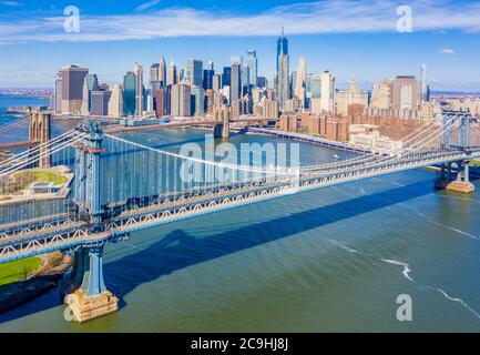 Aerial view of the Brooklyn and Manhattan Bridges with the Lower Manhattan skyline in the background along the East River near Brooklyn Bridge Park Stock Photo